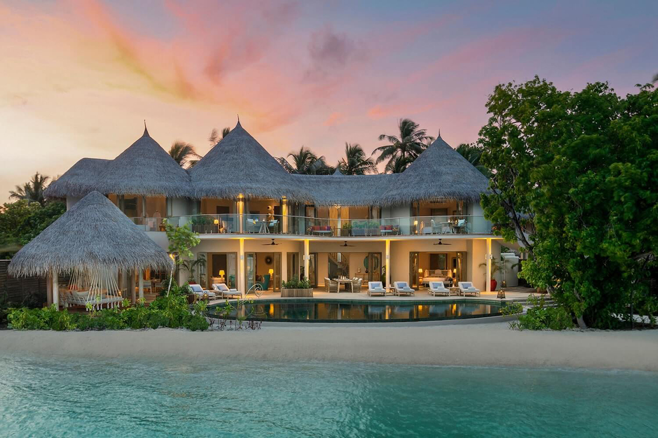 Private Mansion des Malediven Luxusresort The Nautilus mit privatem Poo am indischen Ozean in der Abenddämmerung